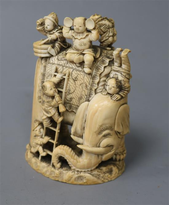 A Japanese ivory okimono of boys clambering on an elephant, Meiji period, height 9.8cm